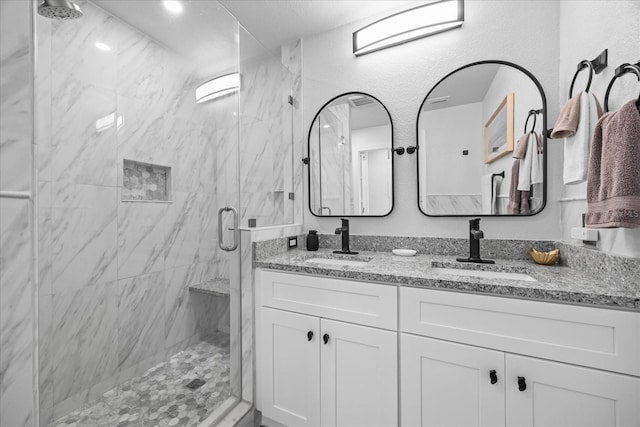 7889 3rd Ave S, Saint Petersburg, FL 33707 - full bathroom featuring a marble finish shower and double vanity
