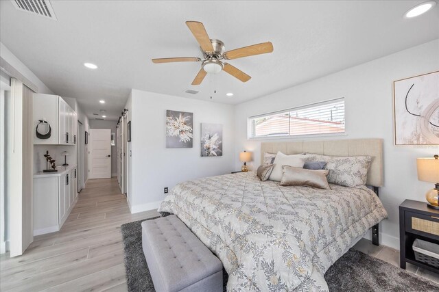 7889 3rd Ave S, Saint Petersburg, FL 33707 - bedroom with baseboards, light wood-type flooring, recessed lighting, and ceiling fan