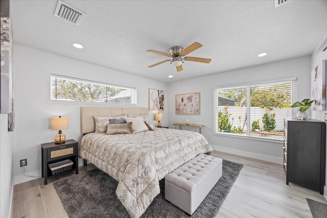 7889 3rd Ave S, Saint Petersburg, FL 33707 - bedroom with multiple windows, recessed lighting, baseboards, and light wood-style floors