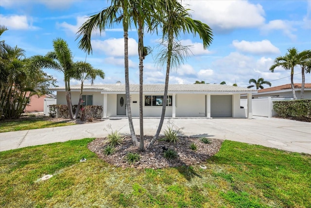 7889 3rd Ave S, Saint Petersburg, FL 33707 - ranch-style home with a garage, driveway, stucco siding, and a tiled roof