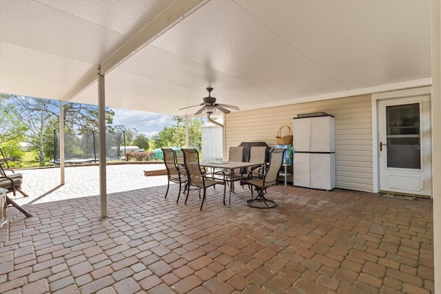 view of patio / terrace with a trampoline, a ceiling fan, and outdoor dining space