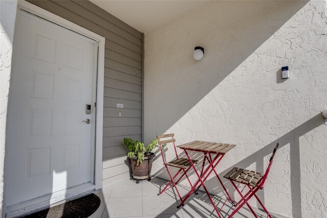 property entrance with stucco siding