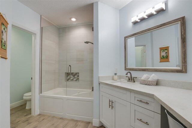 bathroom with recessed lighting, wood finished floors, toilet, vanity, and baseboards