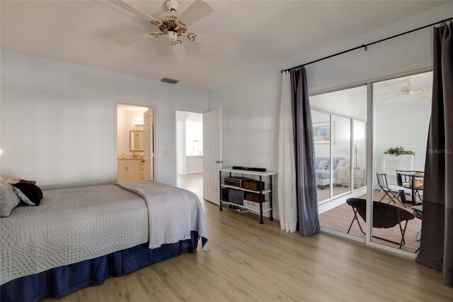 bedroom featuring wood finished floors, visible vents, a ceiling fan, and multiple windows