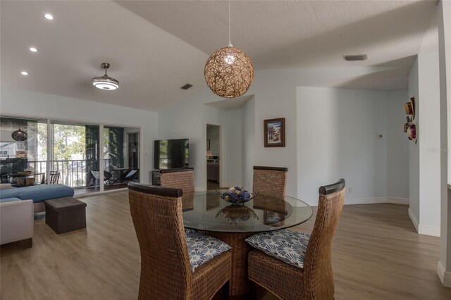dining area with vaulted ceiling, visible vents, baseboards, recessed lighting, and wood finished floors