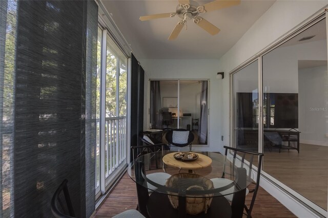sunroom / solarium featuring visible vents, wood finished floors, and a healthy amount of sunlight