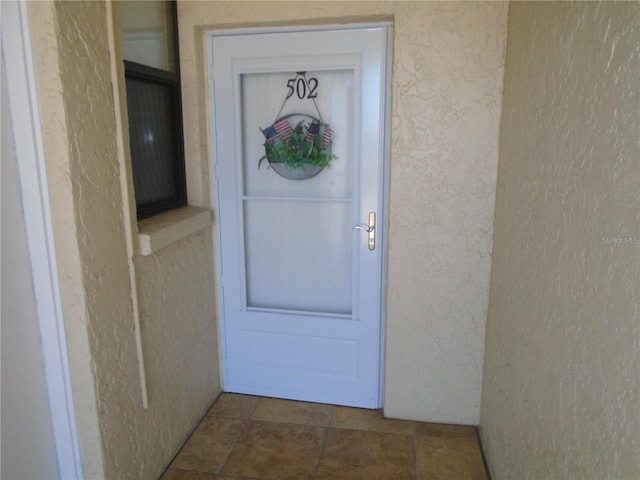 property entrance featuring stucco siding