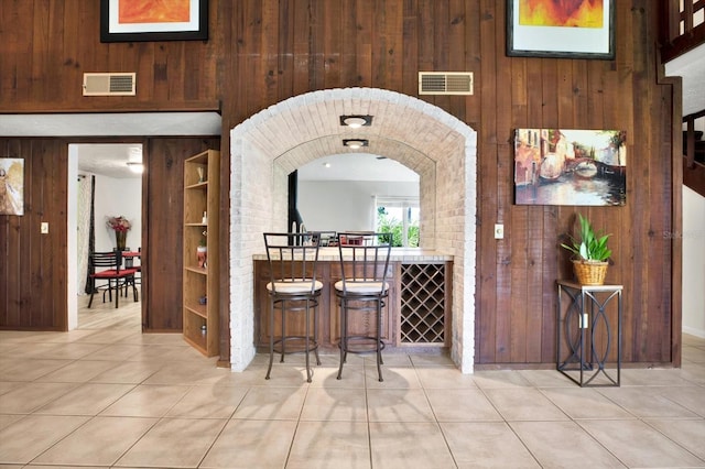 13902 Bardmoor Pl Unit B, Tampa, FL 33618 - indoor dry bar with wooden walls, tile patterned flooring, built in features, and arched walkways