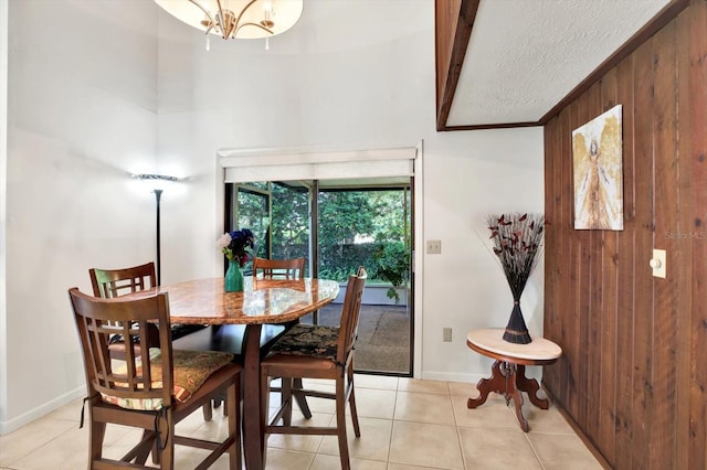 13902 Bardmoor Pl Unit B, Tampa, FL 33618 - dining room featuring light tile patterned flooring, a textured ceiling, baseboards, beamed ceiling, and a chandelier