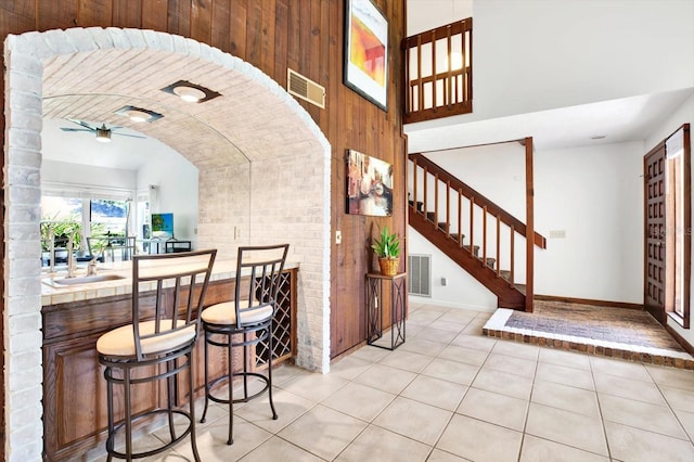 13902 Bardmoor Pl Unit B, Tampa, FL 33618 - entryway featuring light tile patterned flooring, vaulted ceiling, stairway, baseboards, and ceiling fan
