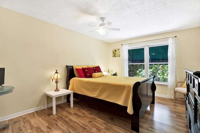 13902 Bardmoor Pl Unit B, Tampa, FL 33618 - bedroom with wood finished floors, baseboards, a textured ceiling, and ceiling fan