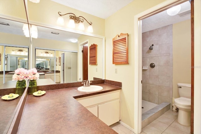 13902 Bardmoor Pl Unit B, Tampa, FL 33618 - full bath featuring tile patterned floors, toilet, a tile shower, and vanity