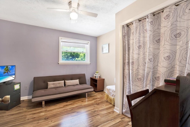 13902 Bardmoor Pl Unit B, Tampa, FL 33618 - sitting room with wood finished floors, a ceiling fan, a textured ceiling, and baseboards