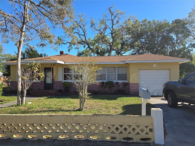 1125 Engman St, Clearwater, FL 33755 - ranch-style home featuring brick siding, a garage, and driveway