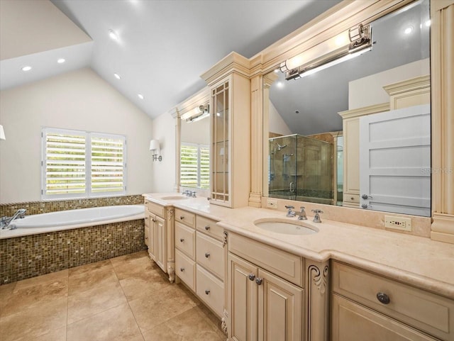 bathroom with vaulted ceiling, plenty of natural light, and a sink