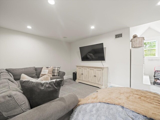 carpeted living area featuring visible vents, recessed lighting, and baseboards
