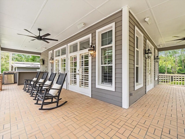 view of patio / terrace with covered porch, french doors, and a ceiling fan