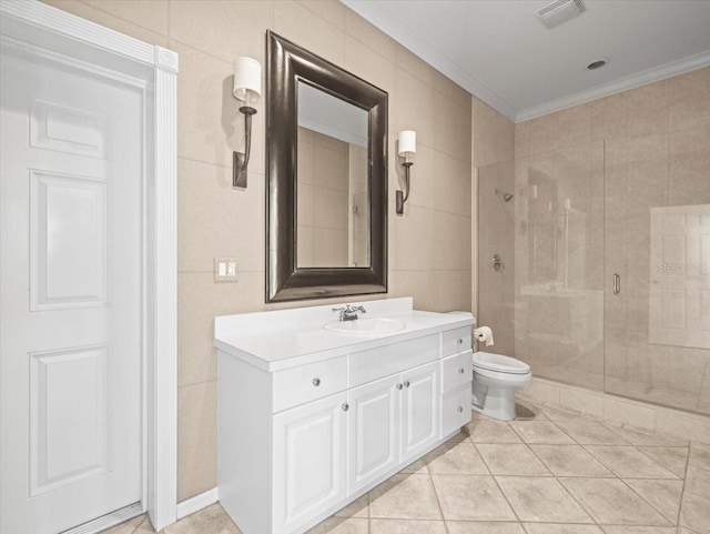 bathroom featuring a shower stall, ornamental molding, toilet, vanity, and visible vents