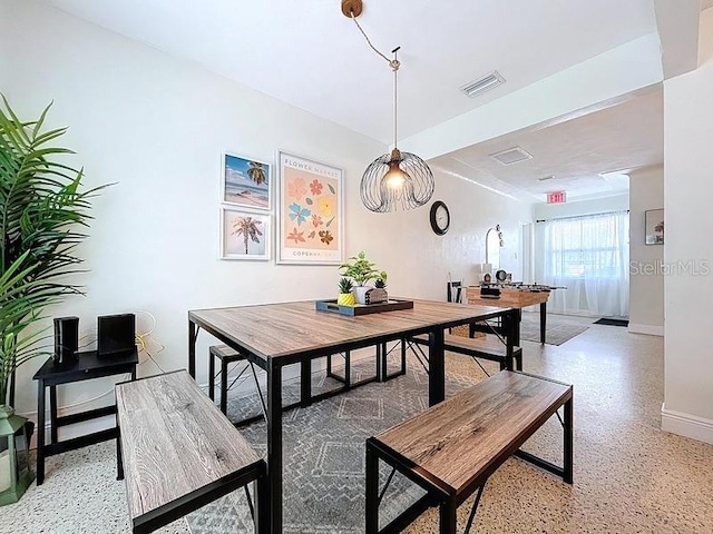 dining space featuring visible vents, baseboards, and light speckled floor