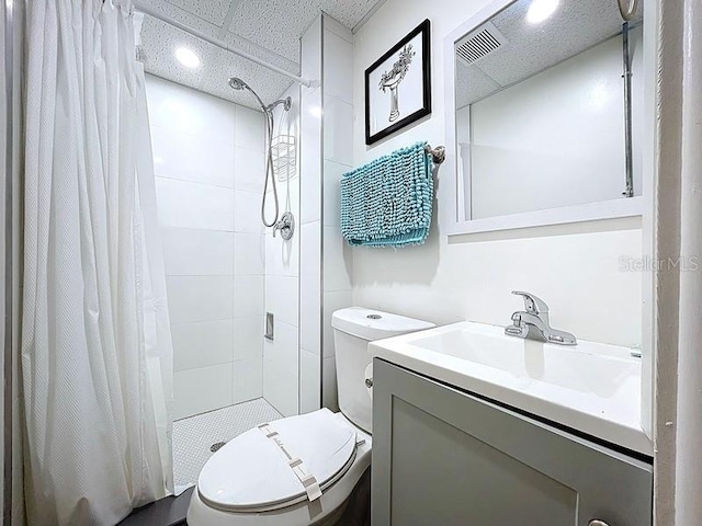full bath with toilet, a shower stall, a paneled ceiling, and vanity