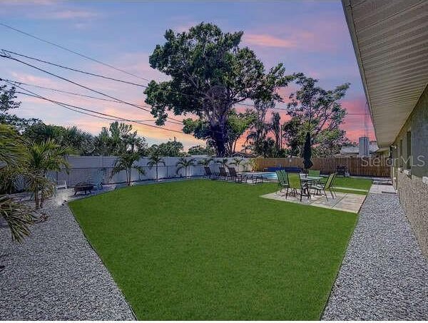 view of yard featuring a fenced in pool, a patio, and a fenced backyard