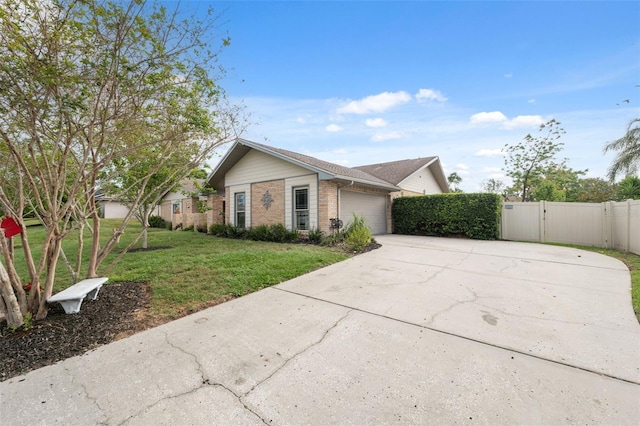 2906 Beagle Pl, Seffner, FL 33584 - view of front facade with a garage, brick siding, a front lawn, a gate, and driveway