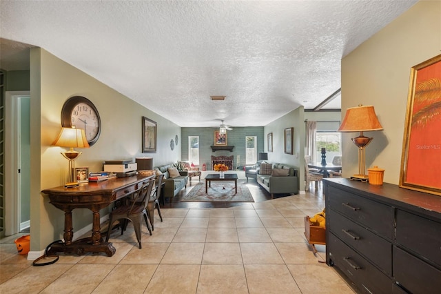 2906 Beagle Pl, Seffner, FL 33584 - living room with baseboards, ceiling fan, a textured ceiling, a fireplace, and light tile patterned flooring