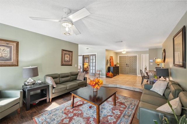 2906 Beagle Pl, Seffner, FL 33584 - living room featuring a textured ceiling, french doors, wood finished floors, and a ceiling fan