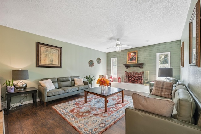 2906 Beagle Pl, Seffner, FL 33584 - living room featuring baseboards, a ceiling fan, a fireplace, a textured ceiling, and wood finished floors