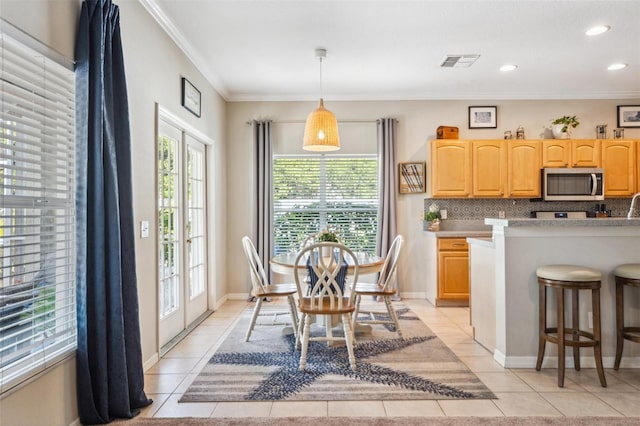 11519 Cypress Reserve Dr, Tampa, FL 33626 - dining area with ornamental molding, visible vents, light tile patterned floors, and a healthy amount of sunlight