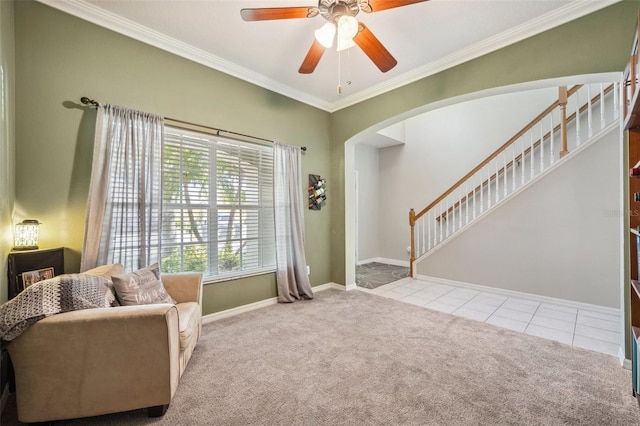 11519 Cypress Reserve Dr, Tampa, FL 33626 - living area with crown molding, arched walkways, a ceiling fan, tile patterned flooring, and carpet floors