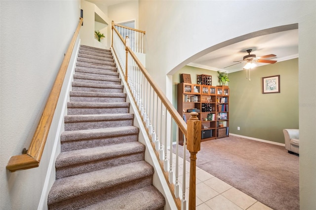 11519 Cypress Reserve Dr, Tampa, FL 33626 - stairway featuring ceiling fan, arched walkways, carpet floors, tile patterned floors, and baseboards
