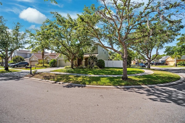 11519 Cypress Reserve Dr, Tampa, FL 33626 - view of front of property with a front yard, an attached garage, fence, concrete driveway, and a residential view