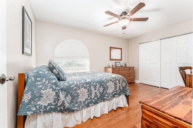 bedroom with a closet, a ceiling fan, and wood finished floors