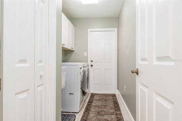 laundry area with cabinet space, washer and clothes dryer, and baseboards
