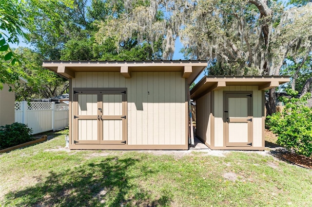 view of shed with fence