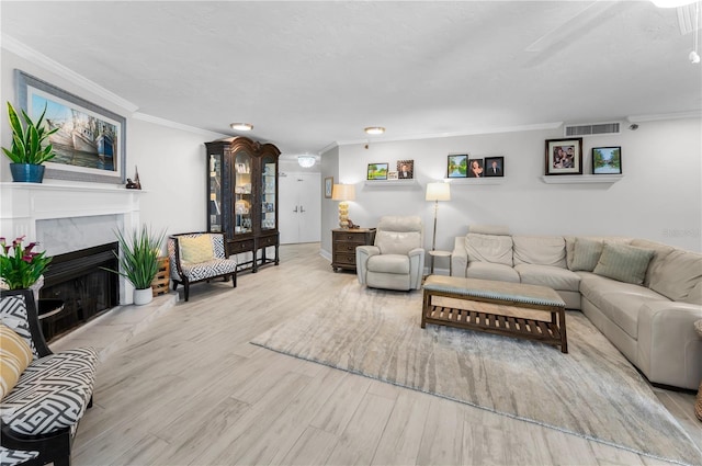1600 Gulf Blvd Unit 212, Clearwater Beach, FL 33767 - living room with visible vents, ornamental molding, wood finished floors, and a high end fireplace