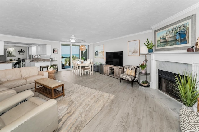 1600 Gulf Blvd Unit 212, Clearwater Beach, FL 33767 - living room featuring a ceiling fan, ornamental molding, and light wood-type flooring