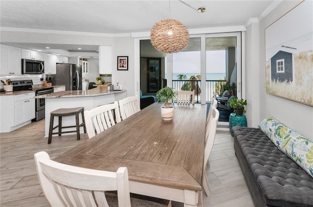 1600 Gulf Blvd Unit 212, Clearwater Beach, FL 33767 - dining area with light wood-style floors and ornamental molding