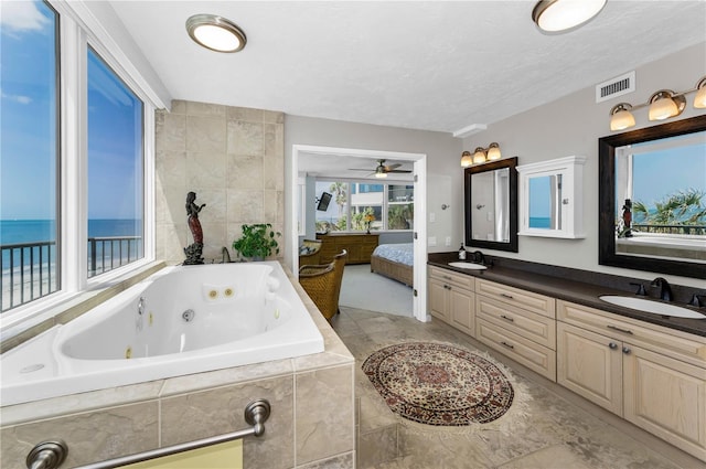 1600 Gulf Blvd Unit 212, Clearwater Beach, FL 33767 - bathroom with visible vents, a sink, ensuite bath, and a tub with jets