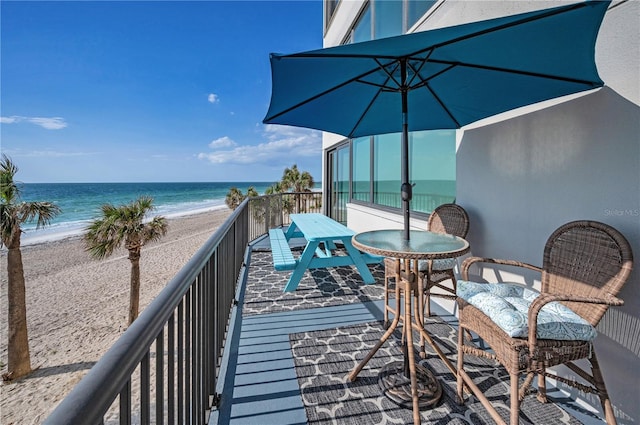 1600 Gulf Blvd Unit 212, Clearwater Beach, FL 33767 - balcony featuring a sunroom, a water view, outdoor dining area, and a view of the beach