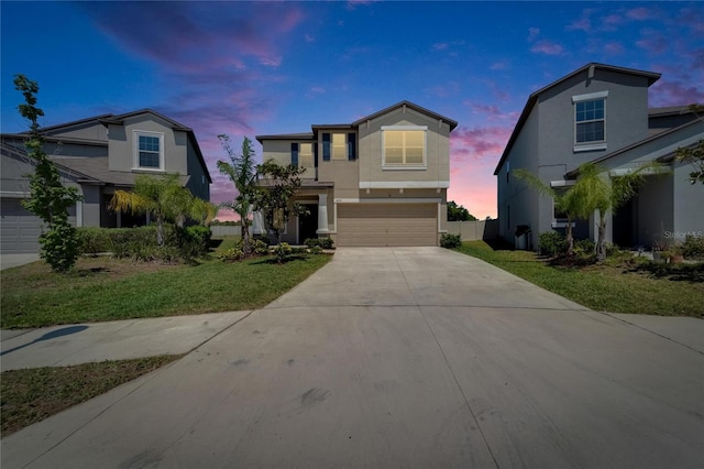 view of front of home with driveway, a garage, and stucco siding