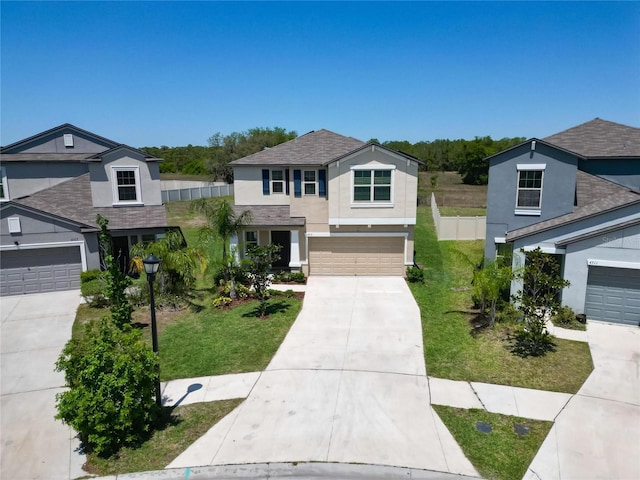 traditional-style home featuring driveway, stucco siding, fence, and a front lawn
