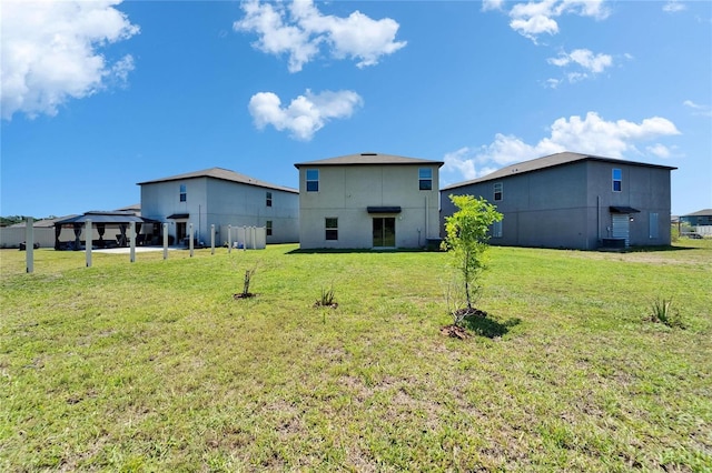 back of house featuring a yard