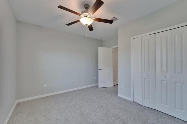 unfurnished bedroom with a closet, baseboards, carpet, and visible vents