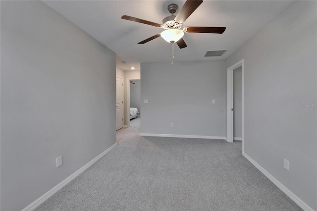 unfurnished room featuring light carpet, ceiling fan, baseboards, and visible vents
