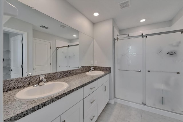 full bath with a shower stall, visible vents, and a sink