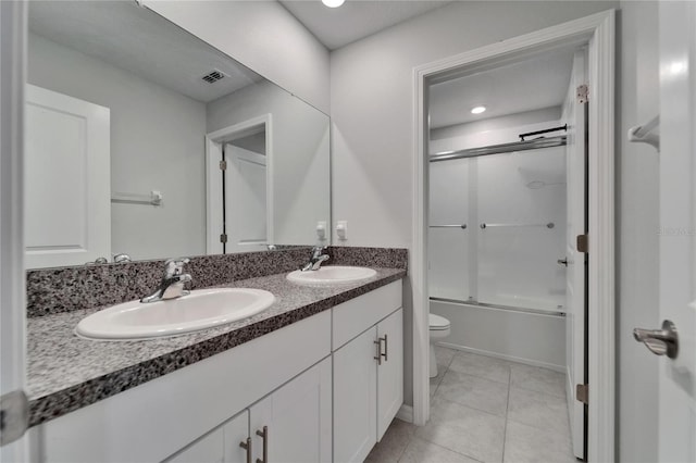 full bath featuring a sink, visible vents, double vanity, and tile patterned flooring