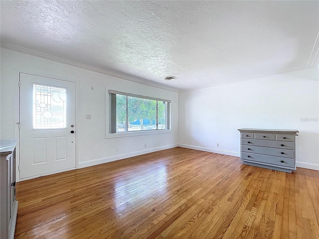 6920 Bougainvilla Ave S, Saint Petersburg, FL 33707 - interior space with light wood-style floors, crown molding, a textured ceiling, visible vents, and baseboards