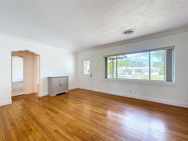 6920 Bougainvilla Ave S, Saint Petersburg, FL 33707 - interior space featuring crown molding, visible vents, light wood-style floors, and a textured ceiling